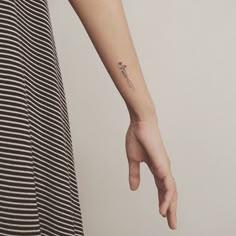 a woman with a small tattoo on her arm