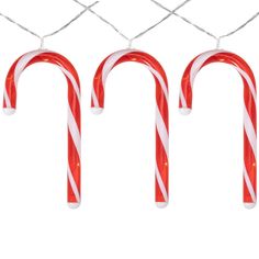 three candy canes hanging from a wire