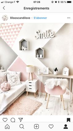 a pink and white room with some shelves on the wall, a small desk and a bed