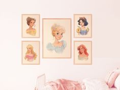 four disney princesses are hanging on the wall above a bed in a girls'bedroom