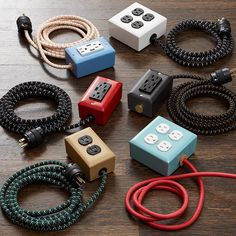 several different types of cords and plugs on a wooden floor with one cord connected to the other