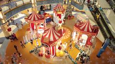 an aerial view of a carnival with people walking around and carousels in the background