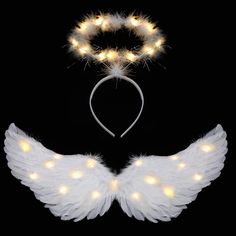 white angel wings with lights and headbands on a black background for halloween decoration