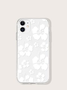 an iphone case with white flowers on the front and back cover, sitting on a gray surface