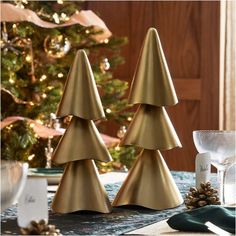 three gold christmas trees sitting on top of a table