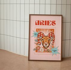 a framed poster with an animal's face on it in front of a tiled wall