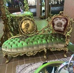 an ornately decorated couch and table in a room with tile flooring on the ground