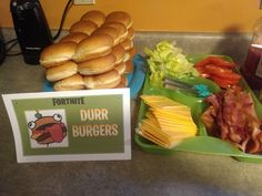 food items displayed on green trays in front of counter top with sign and drink