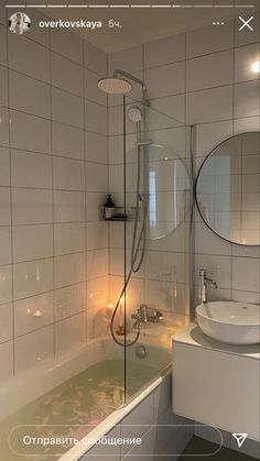 a bathroom with a tub, sink and mirror