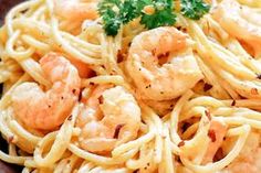 pasta with shrimp and parsley in a brown bowl