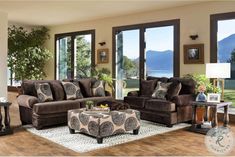 a living room filled with furniture and lots of wood flooring next to large windows