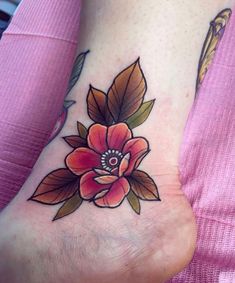 a foot with a flower tattoo on it