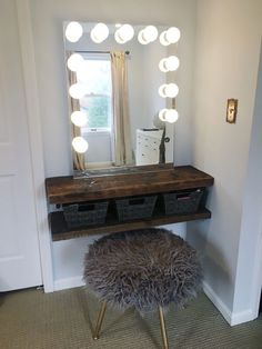 a mirror sitting above a vanity with lights on it's sides and a stool underneath