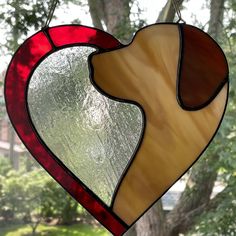 a stained glass heart hanging from a tree