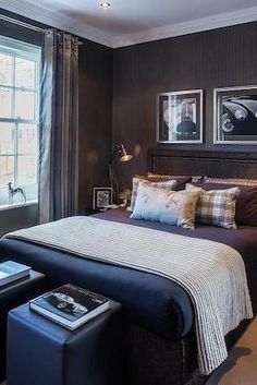 a bed room with a neatly made bed and pictures on the wall