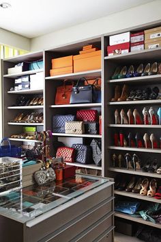 an image of a closet with shoes and purses on the shelves in front of it