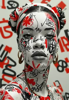 a woman with white and red face paint on her body, wearing large hoop earrings