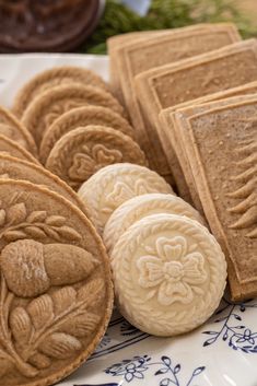 some cookies are sitting on a plate with blue and white designs in the middle, along with another cookie