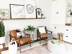 a living room filled with furniture and plants