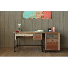 a desk with two drawers and a painting on the wall