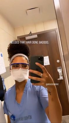 a woman in scrubs is taking a selfie with her phone