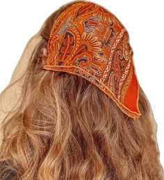 the back of a woman's head wearing an orange bandana