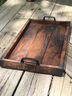 a wooden tray sitting on top of a wooden floor