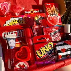 a red basket filled with lots of valentine's day items