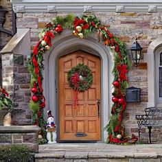 a front door decorated for christmas with wreaths and ornaments