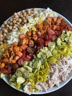 a white plate topped with lots of different types of salads and veggies