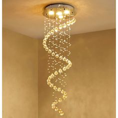 a chandelier hanging from the ceiling in a room with beige walls and flooring