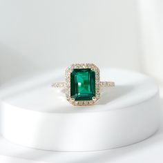 Product Details Add a touch of elegance and beauty to your look with this exquisite Created Emerald Engagement Ring. This simple yet stunning ring features a radiant Created Emerald that is sure to brighten up even the dullest of days. The Created Emerald is further enhanced by delicate Diamond, adding a touch of sparkle and glamour to the ring. Flaunt your style and sophistication with this remarkable Created Emerald Ring, and make a statement wherever you go. Product Information SKU SHP-RINGS112028732 Width 4 mm Height 11.5 mm Weight 2.14 gm (Approximate) LAB CREATED EMERALD INFORMATION No.of Stones 1 Pieces Total Weight 2.31 Carat (Approximate) Dimension(approx) Emerald Cut-7X9 mm-1 Pcs Color Green Cut Brilliant Shape Emerald Cut Setting Type Prong-Setting Quality Grade AAAA DIAMOND INF Emerald Ring With Diamond Halo, Emerald Cut Emerald Engagement Ring, Emerald Green Rings, Emerald Stone Engagement Ring, Emeralds Rings, Green Engagement Ring, Emerald Jewelry Ring, Engagement Rings Emerald, Emerald Halo Engagement Ring