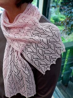 a woman wearing a pink knitted scarf