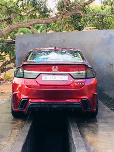 the back end of a red honda car