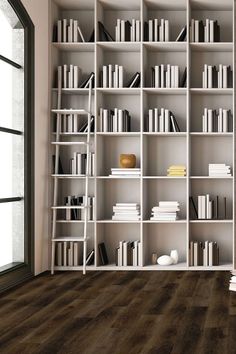 a book shelf filled with lots of books next to an open window in a room