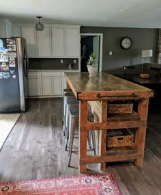 a kitchen with an island made out of wood