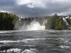 the water is gushing out into the river and it looks like it's going to fall