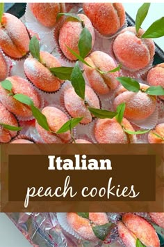 italian peach cookies with powdered sugar on top and green leafy leaves in the middle