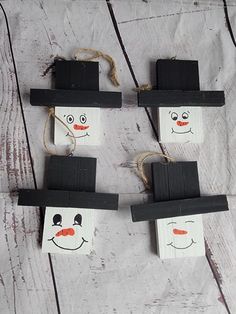 four snowmen made out of small pieces of paper