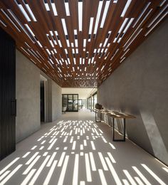 the inside of a building with sunlight coming in through the windows and shadows on the floor