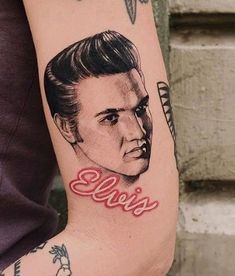 a person with a tattoo on their arm that has the word elvis written across it