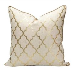 a white and gold pillow on a white background