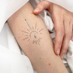 a woman's arm with a clock tattoo on the left side of her body