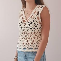 Crochet tank top with flowers, in organic cotton. Superb flower top made with crochet, by hand, with a quality thread that respects the environment. You will support French craftsmanship and slow fashion. Ethical and stylish, go for it! GIFT idea for birthday, Mother's Day, gift for her. Handmade in the South of France Crocheted Handmade Artisan Gift || FEATURES || × Material: 100% organic cotton (Oeko-Tex). × Colors: off-white. This is a unique model, you can place custom orders with me, or cho Hand Knitted Sleeveless Crochet Top For Beach, Bohemian Crochet Cotton Top, Bohemian Crochet Lace Cotton Top, Bohemian Crochet Lace Top In Cotton Yarn, Summer Cotton Tops With Crochet Lace, Cotton Crochet Lace Tank Top For Spring, Hand Knitted Cotton Crochet Top In Bohemian Style, Bohemian Sleeveless Crochet Lace Top, White Cotton Crochet Top