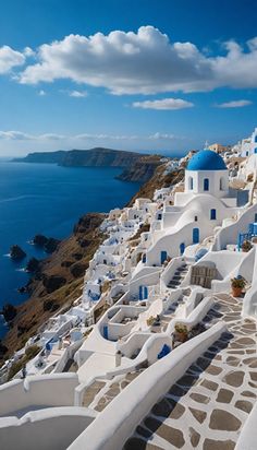 white buildings with blue domes on the side of a cliff overlooking the ocean in oia, greece