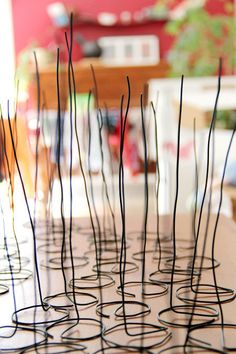 several wire sculptures sitting on top of a table