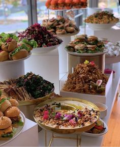 many different types of food are displayed in bowls on display at a buffet or party