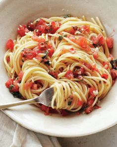 a white bowl filled with pasta and tomato sauce