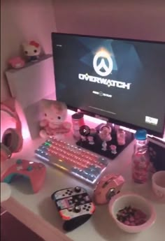 a desktop computer sitting on top of a desk next to a bowl of candy and other items