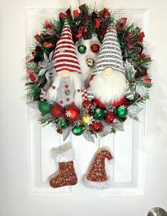 christmas wreath with gnomes and stockings hanging on the front door